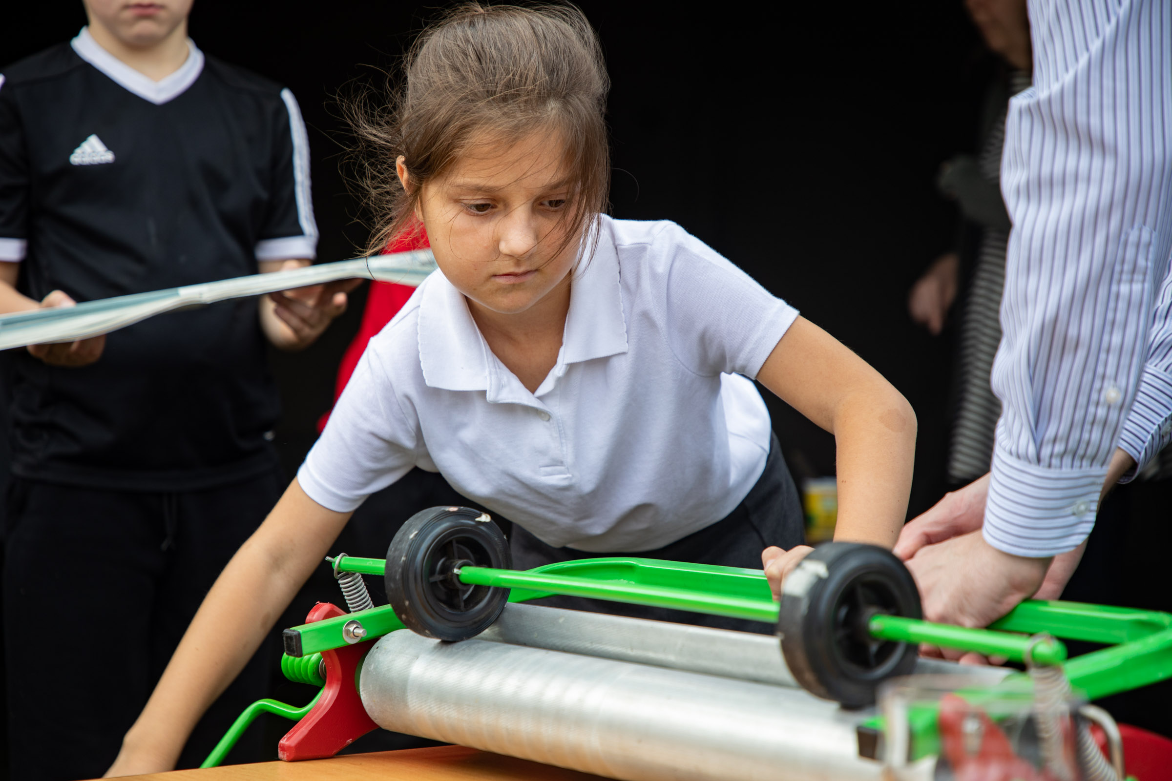 Pupils using a STIXX newspaper roller to create their building materials